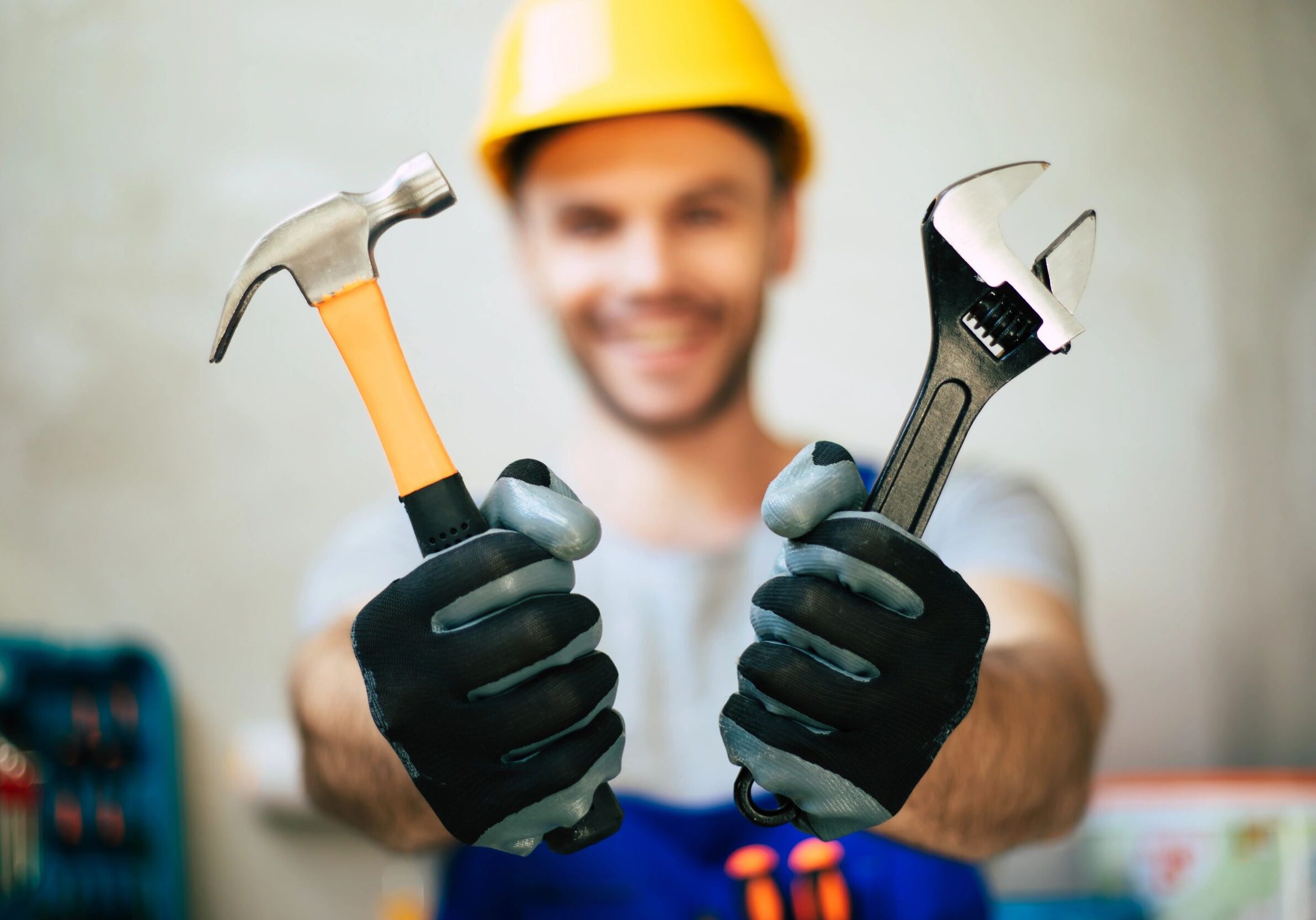 Close up photo of professional repairman in uniform and safety helmet holds in hands modern new tools for work and renovation (Close up photo of professional repairman in uniform and safety helmet holds in hands modern new tools for work and renovatio